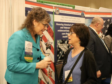 Greenberg chats with a 2018 AAACN Conference attendee in the exhibit hall.